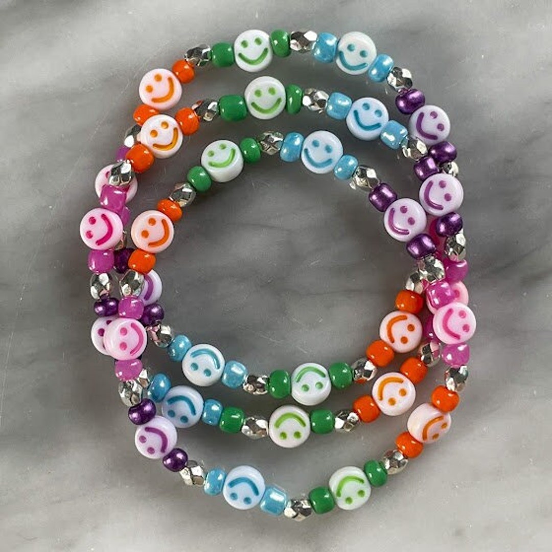 Mixed bead party bracelet. Handmade. Elasticated. Rainbow colours. Smileys,  flowers, hearts and stars. Super cute and colourful.