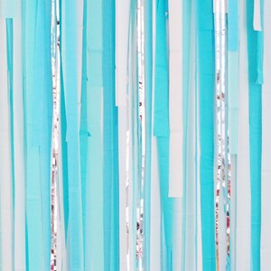 May include: A wall decorated with a curtain of blue and white streamers. The streamers are hanging from the ceiling and are arranged in a random pattern.