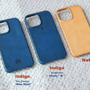 May include: Three leather phone cases in indigo blue and natural tan. The indigo cases have the text "Indigo Eco Design Blue Mind" and "Buddhism Empty 空". The tan case is labeled "Natur".