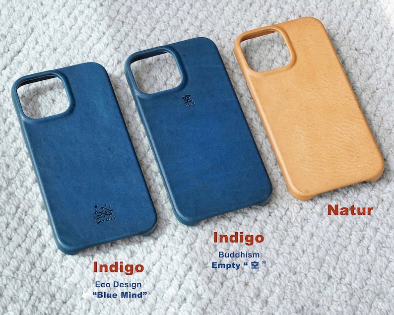 May include: Three leather phone cases in indigo blue and natural tan. The indigo cases have the text "Indigo Eco Design Blue Mind" and "Buddhism Empty 空". The tan case is labeled "Natur".