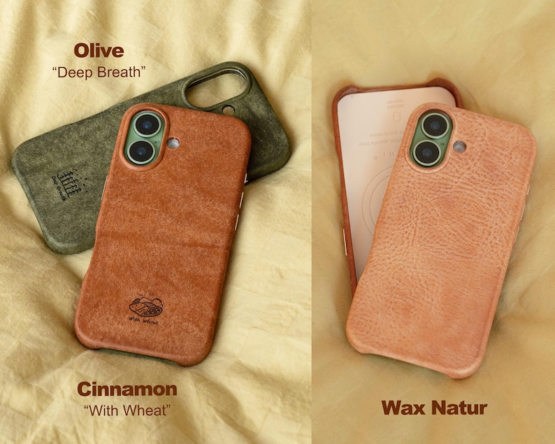 May include: An overhead shot displays three phone cases in various colors. The top case is olive green, the middle case is cinnamon, and the right case is a light peach color. The cinnamon case has the text "With Wheat" and the olive case has the text "Deep Breath".