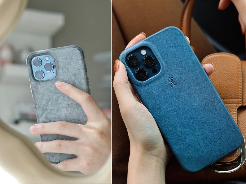May include: Two images of a smartphone in a textured case. One case is gray, the other is blue. The phone has a multi-lens camera. The blue case has a small symbol and text. The phone is held in a hand.