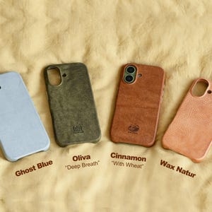 May include: Four phone cases in a row, each with a different color and texture. The colors are Ghost Blue, Oliva, Cinnamon, and Wax Natur. Each case has a cutout for the camera and buttons. The names of the colors are printed below each case.