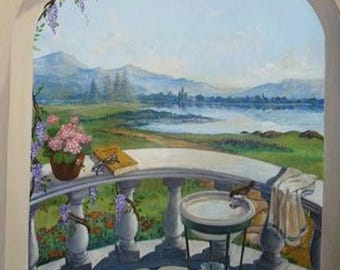 May include: A painted mural depicting a balcony overlooking a serene landscape. The scene includes a white balustrade, a small table with a water basin, a book, and a pot of pink flowers. The background shows a lake and mountains.