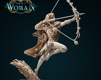 May include: A detailed figurine of a person in a dynamic pose, drawing a bow. The figure is dressed in ornate clothing and a cape, with arrows at the ready. The text "DND IS A WOMAN" is in the upper left corner.