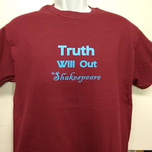 May include: A maroon t-shirt with the text "Truth Will Out Shakespeare" in blue lettering.