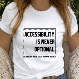 May include: White t-shirt with a black graphic that says "Accessibility is never optional. Disability rights are human rights."
