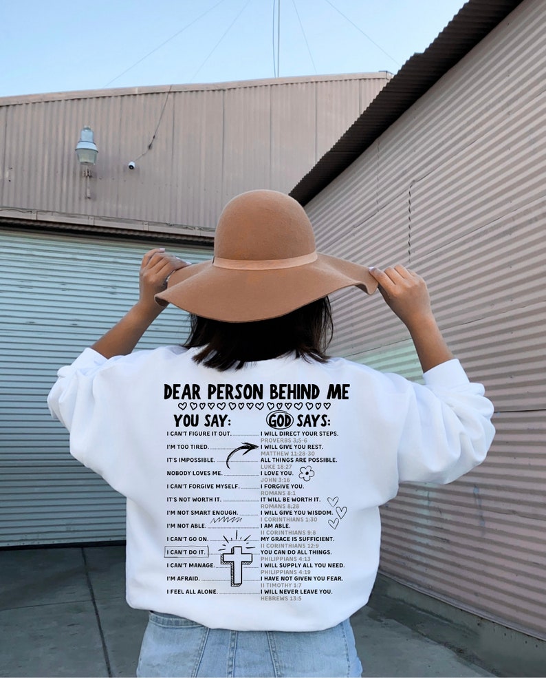 May include: White sweatshirt with a black and white graphic print that says "Dear Person Behind Me You Say: God Says:" with a list of phrases and corresponding bible verses.