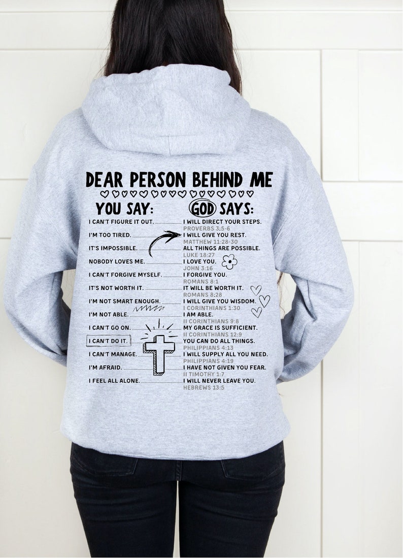 May include: Gray hooded sweatshirt with a motivational message printed on the back. The text reads "Dear person behind me... You say: I can't figure it out... God says: I will direct your steps..." and includes several Bible verses.