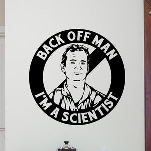 May include: Black and white vinyl wall decal featuring a man's face with the text "Back Off Man I'm A Scientist" in a circle with a diagonal line through it.