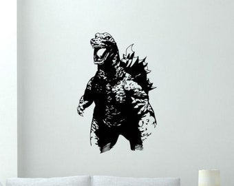 May include: Black and white silhouette of Godzilla, a fictional monster, roaring with its mouth open. The monster has a spiky back and is standing on two legs.
