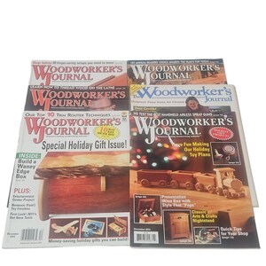May include: A stack of woodworking magazines titled "Woodworker's Journal". The magazines feature articles on various woodworking projects, including toy plans, gift ideas, and shop techniques. The covers display images of wooden projects.