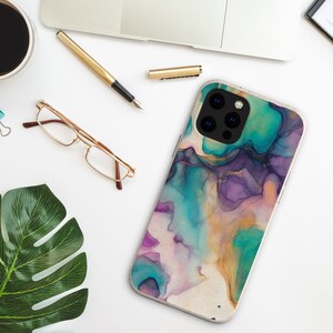 May include: A phone case with a colorful abstract design featuring shades of teal, purple, and gold. The case has a camera cutout with three lenses.