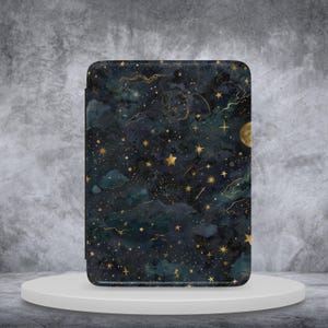 May include: A rectangular case with a celestial design. The case has a dark blue background with gold stars, a crescent moon, and cloud-like shapes. The design has a textured appearance, suggesting a fabric or leather material.