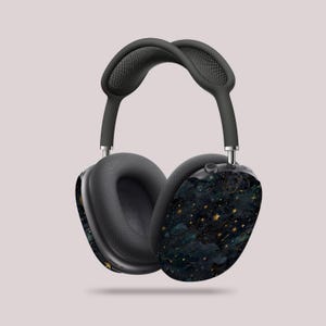 May include: Black headphones with a gold and blue starry night design. The headphones have a padded headband and earcups.