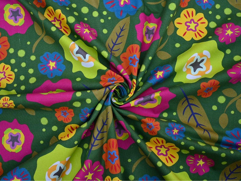 May include: Green fabric with a vibrant floral pattern. The design features large flowers in shades of pink, yellow, orange, and blue, along with green leaves and polka dots. The fabric is tightly swirled, showcasing the colorful print.