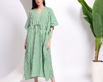 May include: A floor-length kaftan dress featuring a vertical green and white striped pattern, a V-neckline, and short wide sleeves. The garment includes a drawstring waist tie at the center front to adjust the fit, creating a loose, flowing silhouette.