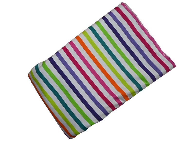May include: A rectangular fabric with a vibrant rainbow stripe pattern. The stripes alternate between white, teal, green, purple, pink, orange, and white. The edges are finished with a pink trim.