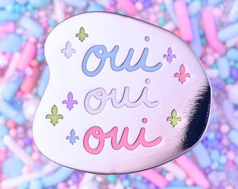 Enamel Pin: "Oui, Oui, Oui" ~ Yes, Yes, Yes in French ~ Pastel Pink, Blue ~ Fleur de Lis ~ Aesthetic Asymmetrical Design ~ Silver, Pale Gold
