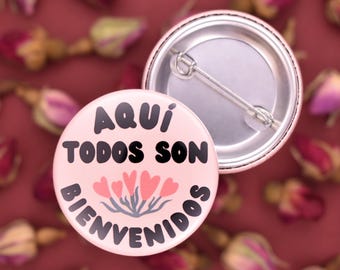Aquí Todos Son Bienvenidos Pinback Button ~ Flower Heart Design ~ Spanish: All Are Welcome Here ~ Badge, Pin ~ Six Color Combos