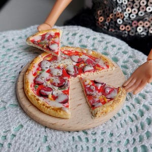 Miniature pizza for a dollhouse. Pizza for a doll. Food for a dollhouse.