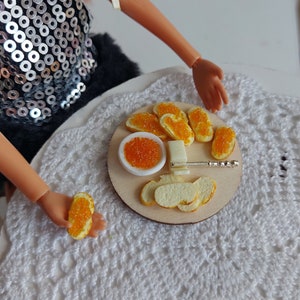 Bread for the doll. Food for a doll. Sandwiches with butter and red caviar for a doll.