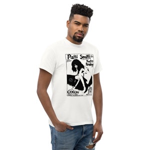May include: White t-shirt with a black and white image of Patti Smith with the text "Patti Smith Poetry Reading" and "Odeon" on the front.