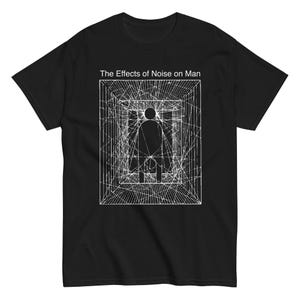May include: Black t-shirt featuring a white graphic design. The design includes a figure within a rectangular frame, with the text "The Effects of Noise on Man" above the graphic. The graphic has a geometric, abstract style.
