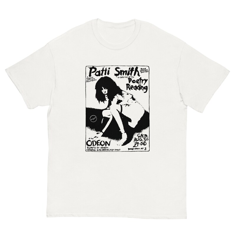 May include: Black and white graphic t-shirt featuring a vintage concert poster for Patti Smith's Poetry Reading at the Odeon on August 30th, 1978. The poster features a silhouette of Patti Smith in a pose with the text "Patti Smith Poetry Reading" and "Odeon" at the bottom.