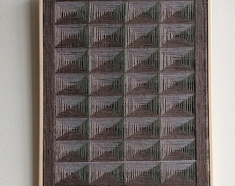 May include: A framed wall art piece with a geometric pattern made of woven brown and white threads. The pattern is a series of squares within squares, creating a visually interesting and textured design.