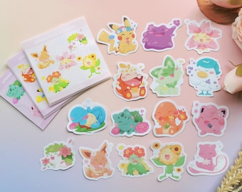 May include: A collection of colorful stickers featuring various cartoon characters adorned with floral elements. The stickers are arranged on a light pink surface, with a stack of sticker sheets visible. The text "SPRING POKÉ STICKERS" is printed on the sticker sheets.