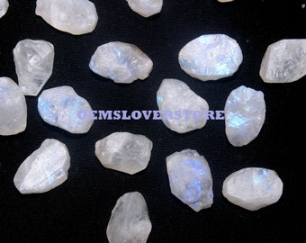 May include: A collection of 17 raw, white moonstone crystals with iridescent blue and purple hues. The crystals are various shapes and sizes, and some have a rough, natural texture.