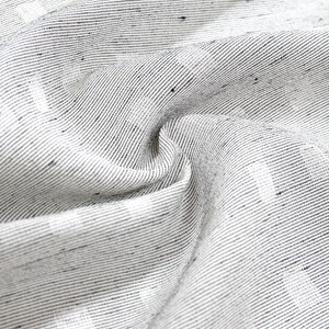 May include: Close-up of a white fabric with a subtle black and white striped pattern. The fabric is woven and has a slightly textured surface.