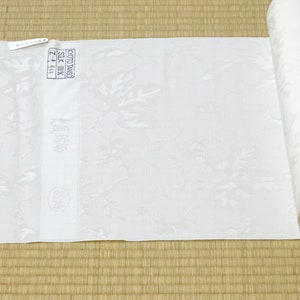 May include: A white fabric roll with a floral pattern. The fabric is labeled "Kyoto Tango Silk 100% Z-4-614".