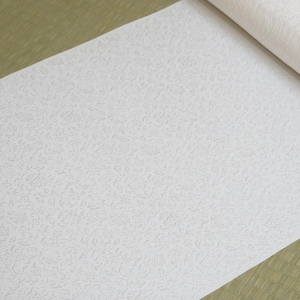 May include: A white roll of wallpaper with a subtle embossed pattern of small, swirling designs.