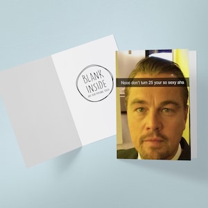 May include: A white greeting card with the text "Blank Inside" in a black circle. The card is open, revealing a photo of a man with the text "Nooo don't turn 25 your so sexy aha".