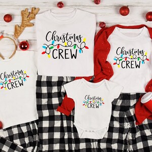 May include: A family of four wearing matching white pajamas with black and white plaid pants. The shirts have the text "Christmas Crew" with a string of colorful lights.
