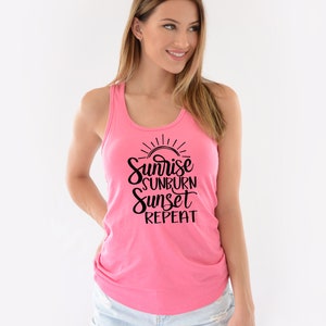 May include: A pink tank top with a black graphic that says "Sunrise Sunburn Sunset Repeat".