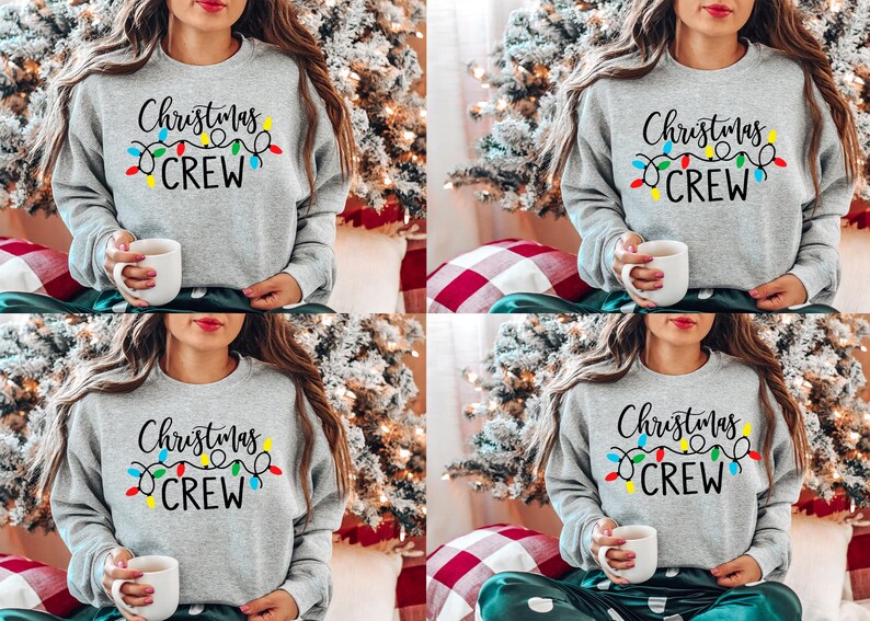 May include: Four women wearing gray sweatshirts with the text "Christmas Crew" and colorful string lights. The sweatshirts are a casual, comfortable style.