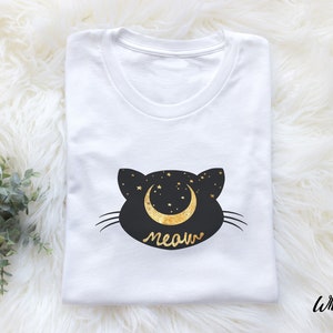 May include: White t-shirt with a black cat silhouette design. The cat has a crescent moon with stars on its head and the word "meow" underneath.