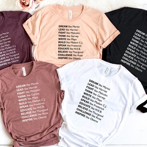 May include: Five t-shirts in different colors with the text "DREAM like Martin, LEAD like Harriet, FIGHT like Malcolm, THINK like Garvey, WRITE like Maya, BUILD like Madam CJ, SPEAK like Frederick, EDUCATE like WEB, BELIEVE like Thurgood, CHALLENGE like Rosa, INSPIRE like Obama" printed on them.