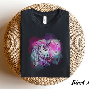 May include: Black t-shirt with a colorful graphic of a unicorn's head inside a heart shape.