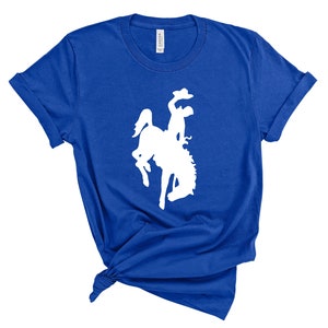 May include: A royal blue t-shirt with a white silhouette of a bucking bronco.