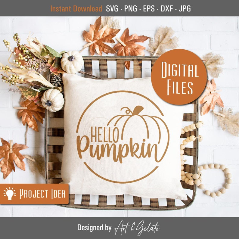 May include: A white pillow with a brown circle design featuring the text "HELLO pumpkin" and a pumpkin graphic. The pillow is sitting in a wooden crate with fall-themed decorations.