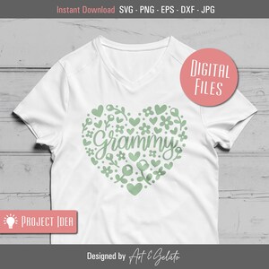 May include: A white t-shirt with a green heart design featuring the word "Grammy" surrounded by small hearts and flowers. The design is perfect for a grandmother.