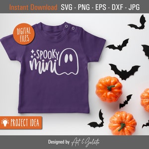 May include: Purple baby onesie with a white ghost and the text "SPOOKY mini" on the front. The onesie is surrounded by black bats and orange pumpkins.
