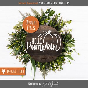 May include: A round wooden sign with the text "Hello Pumpkin" in white lettering. A white outline of a pumpkin is above the text. The sign is surrounded by green leaves and white flowers.