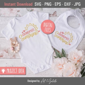 May include: A white onesie and a white bib with a gold sun and the text "Grandma's Sunshine" in pink and gold. The onesie and bib are on a white wooden surface with pink flowers.