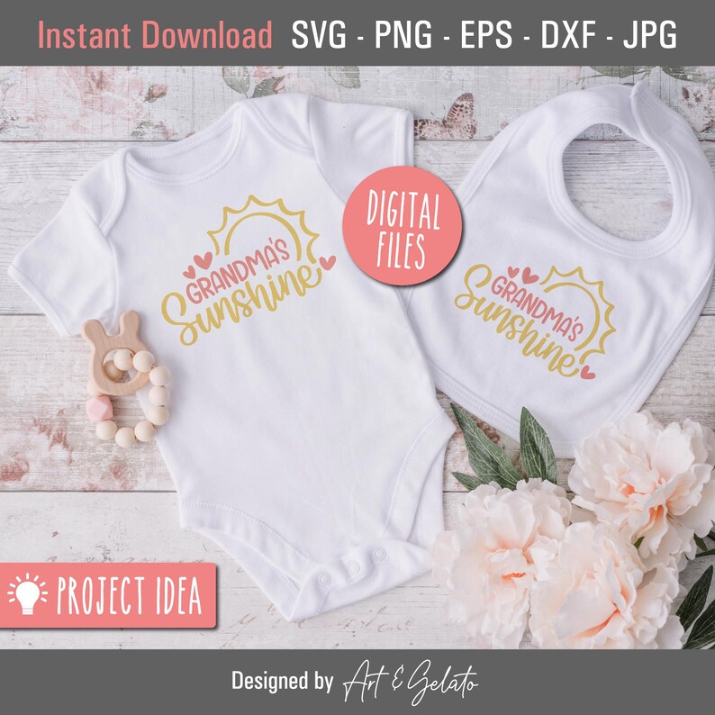May include: A white onesie and a white bib with a gold sun and the text "Grandma's Sunshine" in pink and gold. The onesie and bib are on a white wooden surface with pink flowers.