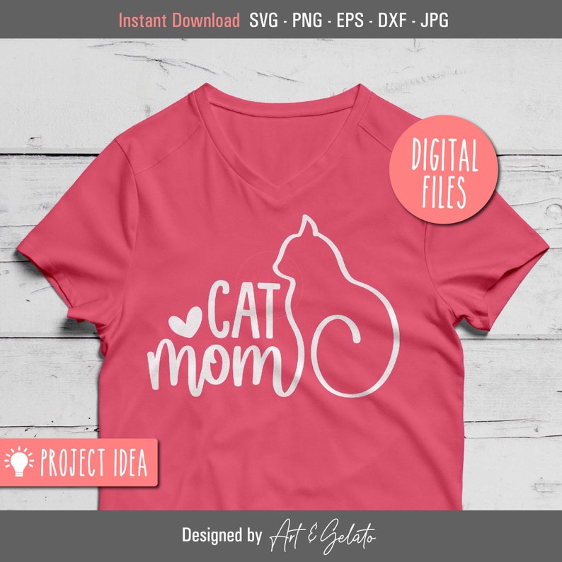 May include: A pink t-shirt with a white silhouette of a cat and the text "CAT MOM" in white cursive lettering.